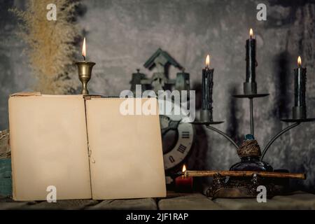 Antique parchment paper sheets roll tied with string lit by candlelight on a vintage colonial wood desk with ink writing feather quill and old candle Stock Photo