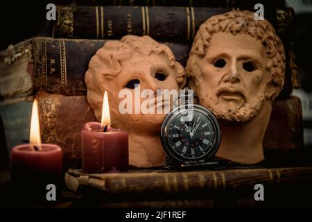 Pocket watch and old book, hourglass on dark background. Journey and Learning Concept, Vintage Style. Stock Photo