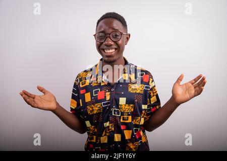 African usinessman with open arms and surprised expression, photo taken in studio Stock Photo