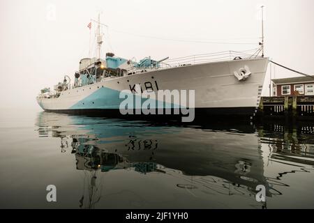 Last remaining Flower-class corvette HMCS Sackville reflects on the calm water of Halifax Harbour, Nova Scotia, Canada. Stock Photo