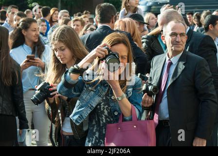 Female photographer in action. Stock Photo