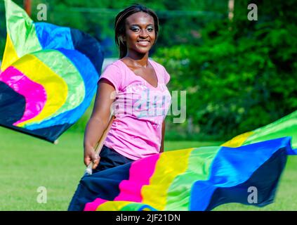 A member of the Columbus High School color guard twirls her flags during band practice, Aug. 16, 2012, in Columbus, Mississippi. Stock Photo
