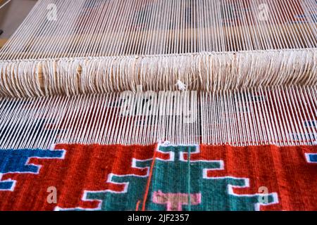 Close up, Detail of loom for weaving traditional handmade carpets, rugs.  Weaving and manufacturing of Turkish style homemade carpets. Selective focus Stock Photo