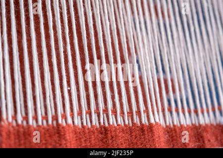 Close up, Detail of loom for weaving traditional handmade carpets, rugs.  Weaving and manufacturing of Turkish style homemade carpets. Selective focus Stock Photo