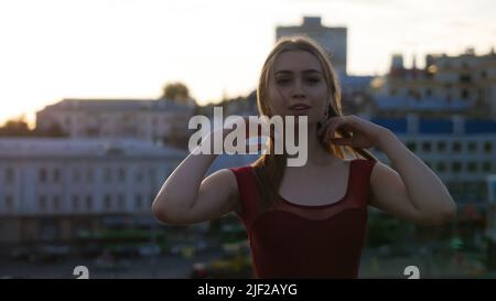 Attractive woman in red balet tiptoe posing for the photo on the outdoor Stock Photo