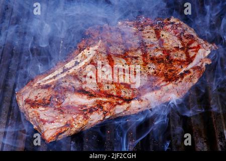 herb marinated american angus beef rib in a hot bbq grill Stock Photo ...