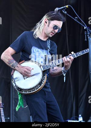 Banjo player Kyle Tuttle is shown performing on stage during a “live” concert appearance with Molly Tuttle and Golden Highway at the Green River Festival. Stock Photo