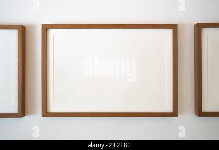 Wooden photo frames on white wall Stock Photo
