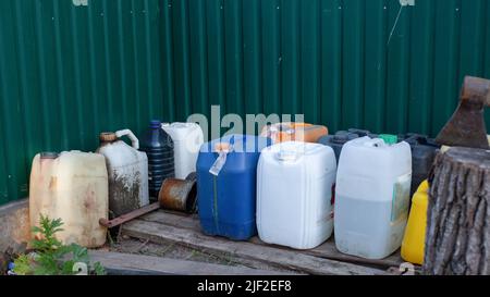 Fuel stocks on the agricultural farm during the shortage of diesel fuel. Old canisters on the farm Stock Photo