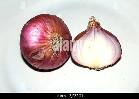 Red whole and sliced onion, isolated on white background Stock Photo