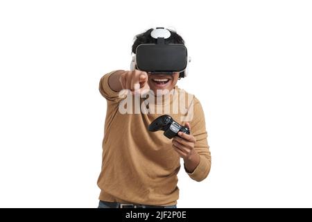Young peruvian man playing games with joystick and vr headset, isolated. Stock Photo