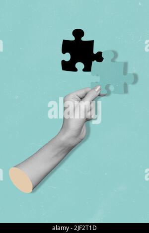 Vertical composite collage picture of human hand fingers black white effect hold last piece puzzle isolated on creative background Stock Photo