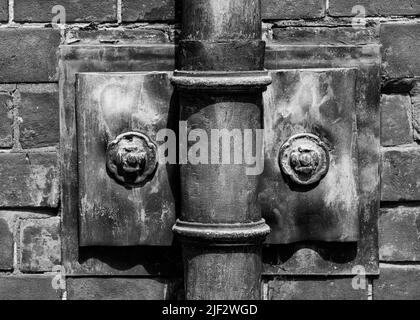 Ornate design old fashioned lead down pipe and wall fixing waste rain water disposal Stock Photo