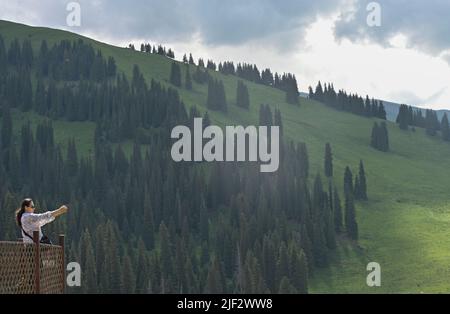 Yining, China's Xinjiang Uygur Autonomous Region. 28th June, 2022. A visitor takes photos at the Narat scenic spot in Xinyuan County, northwest China's Xinjiang Uygur Autonomous Region, June 28, 2022. Credit: Hao Jianwei/Xinhua/Alamy Live News Stock Photo