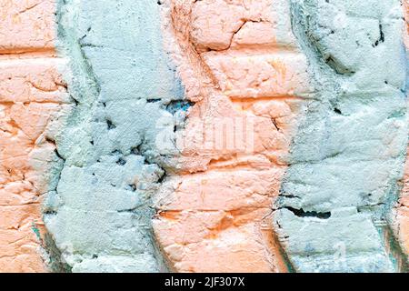 The surface texture of an old used tire with cracks from a truck car is painted with strips of pastel soft pink and blue. Close-up bright summer color Stock Photo