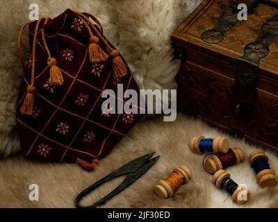 sewing set with spools of wool scissors and a cloth bag on a fur Stock Photo