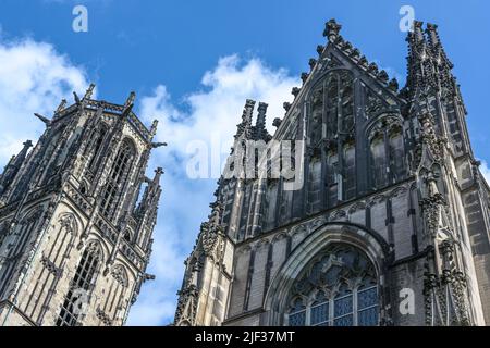 Tower and side gable of the St. Salvator Church in Duisburg, the Gothic basilica is today a Protestant city church, blue sky with white clouds, German Stock Photo