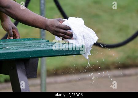 London, UK, 29th June 2022: An employee dries a table at the All England Lawn Tennis and Croquet Club in London. Credit: Frank Molter/Alamy Live news Stock Photo