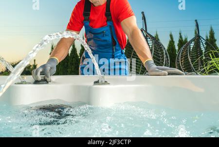 Spa Technician Performing Hot Tub Necessary Checks Right After Installation Residential Garden SPA. Stock Photo