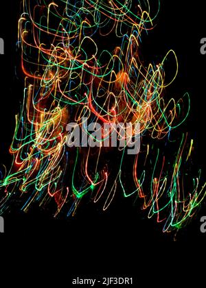 Multicolored dynamic curving light trails. Blurred lights trails making  pattern on  background. Stock Photo