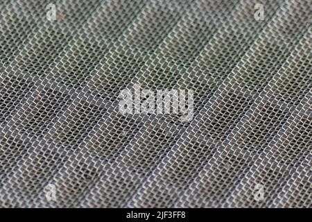 Solid metal mesh over metal grid as solid filter for particles in heavy industry products for durability Stock Photo