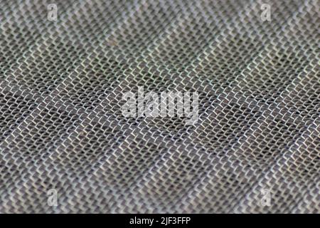 Solid metal mesh over metal grid as solid filter for particles in heavy industry products for durability Stock Photo