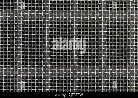 Solid metal mesh over metal grid as solid filter for particles in heavy industry products for durability Stock Photo
