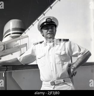 1965, historical, Chief officer of the Sagajford cruise ship standing out on the deck. Built for the Norwegian America Line, the MS Sagafjord was a luxury ocean liner/cruise ship, whose maiden voyage was from Oslo to New York city was in October 1965. Stock Photo