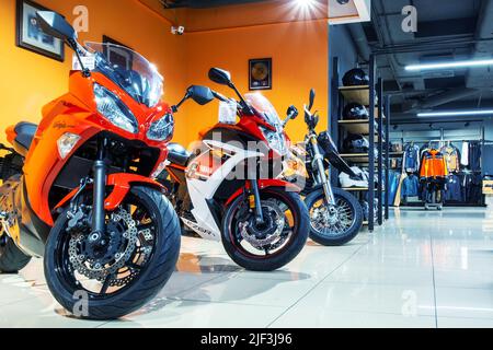 Minsk, Belarus - June 07, 2022: In a motorcycle shop. Motorcycles, motorcycle helmets, ammunition. Stock Photo