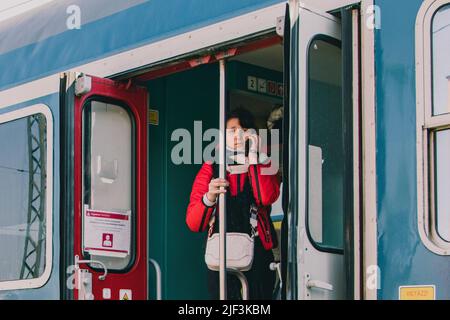 March 6, 2022, ZÂ·hony, Szabolcs-SzatmÃr-Bereg, Hungary: Ukrainian woman is talking on her phone. The train station in ZÃhony is the main access point of Hungary for thousands of refugees fleeing the Russian invasion. (Credit Image: © Lara Hauser/SOPA Images via ZUMA Press Wire) Stock Photo