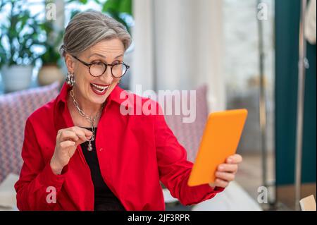Woman showing decoration in smartphone screen Stock Photo
