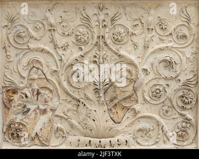 Ancient roman marble wall decorated with a carved floral pattern Stock Photo