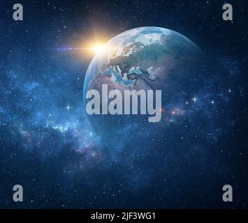 Planet Earth, viewed from space focusing on Western Europe. Earth globe in deep space, stars shining and sun rising on the horizon. Stock Photo