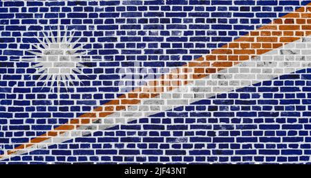 Close-up on a brick wall with the flag of the Marshall Islands painted on it. Stock Photo