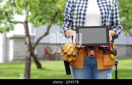 woman builder with working tools showing tablet pc Stock Photo