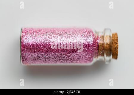 pink glitters in bottle over white background Stock Photo