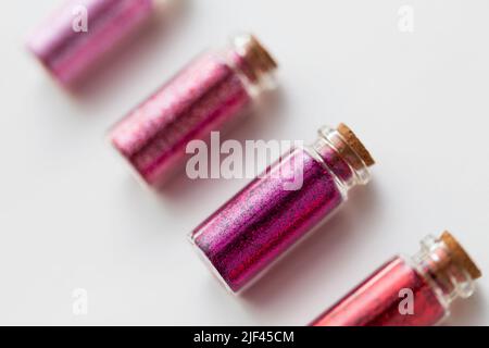 red glitters in bottles over white background Stock Photo