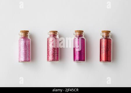 red glitters in bottles over white background Stock Photo