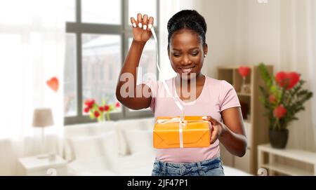 happy african american woman with gift box Stock Photo