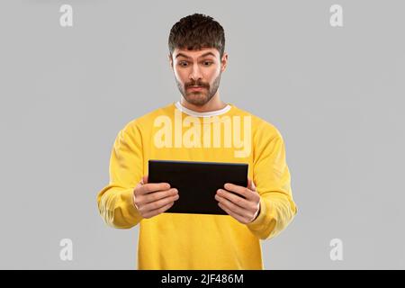 surprised young man with tablet pc computer Stock Photo