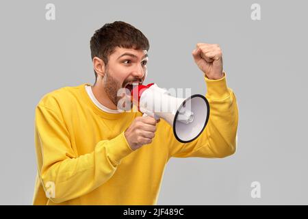 angry man shouting to megaphone Stock Photo