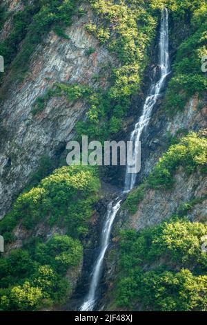 Unnamed waterfall alongside the more famous Bridal Veil Falls down cliffs of Keystone Canyon outside Valdez in Alaska Stock Photo