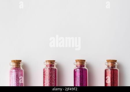 red glitters in bottles over white background Stock Photo