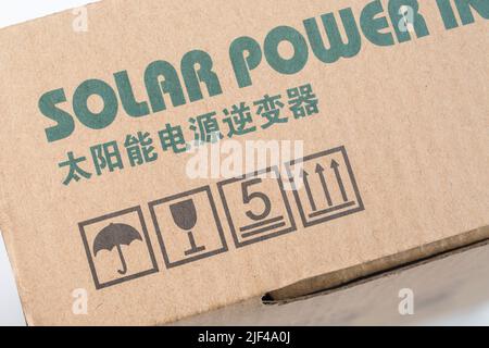 Chinese solar power inverter packaging box with printed international packing symbols. Keep dry symbol, keep upright icon, box stacking, breakable. Stock Photo
