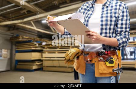 female worker with clipboard and working tools Stock Photo