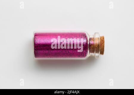 pink glitters in bottle over white background Stock Photo