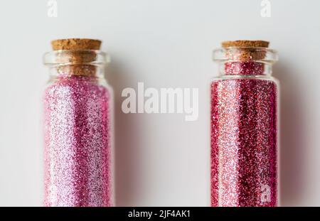 red glitters in bottles over white background Stock Photo