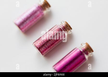 red glitters in bottles over white background Stock Photo