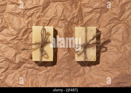 Natural handmade soaps on brown crumpled, wrinkled recycle craft paper background, top view. Zero waste, eco friendly vegan soap bars Stock Photo