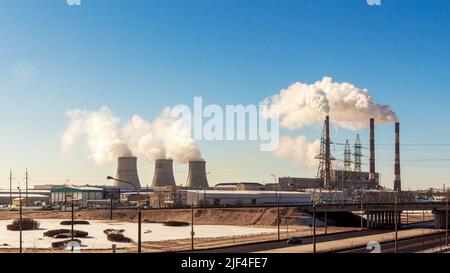 Minsk, Belarus - February 15, 2017: Industrial landscape. Smoke from the pipes of a thermal power plant Stock Photo